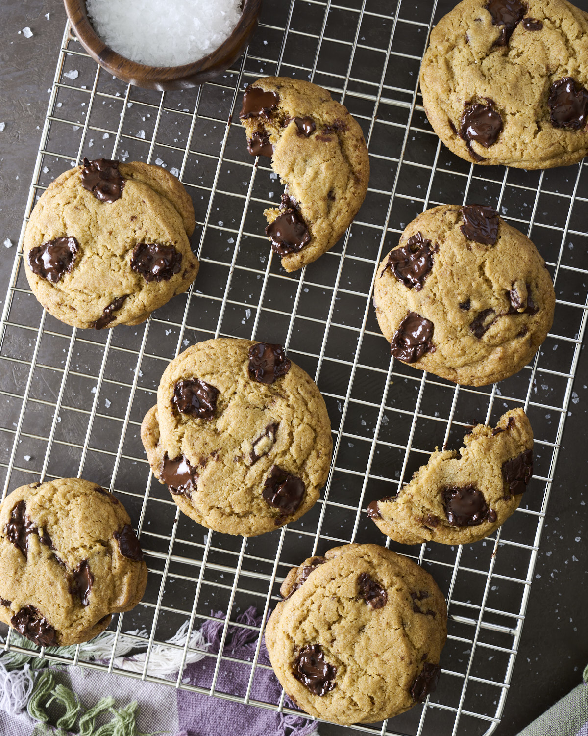 Freshly baked Brown Butter Chocolate Chunk Cookies cooling on a wire rack with crisp golden edges and gooey chocolate chunks.