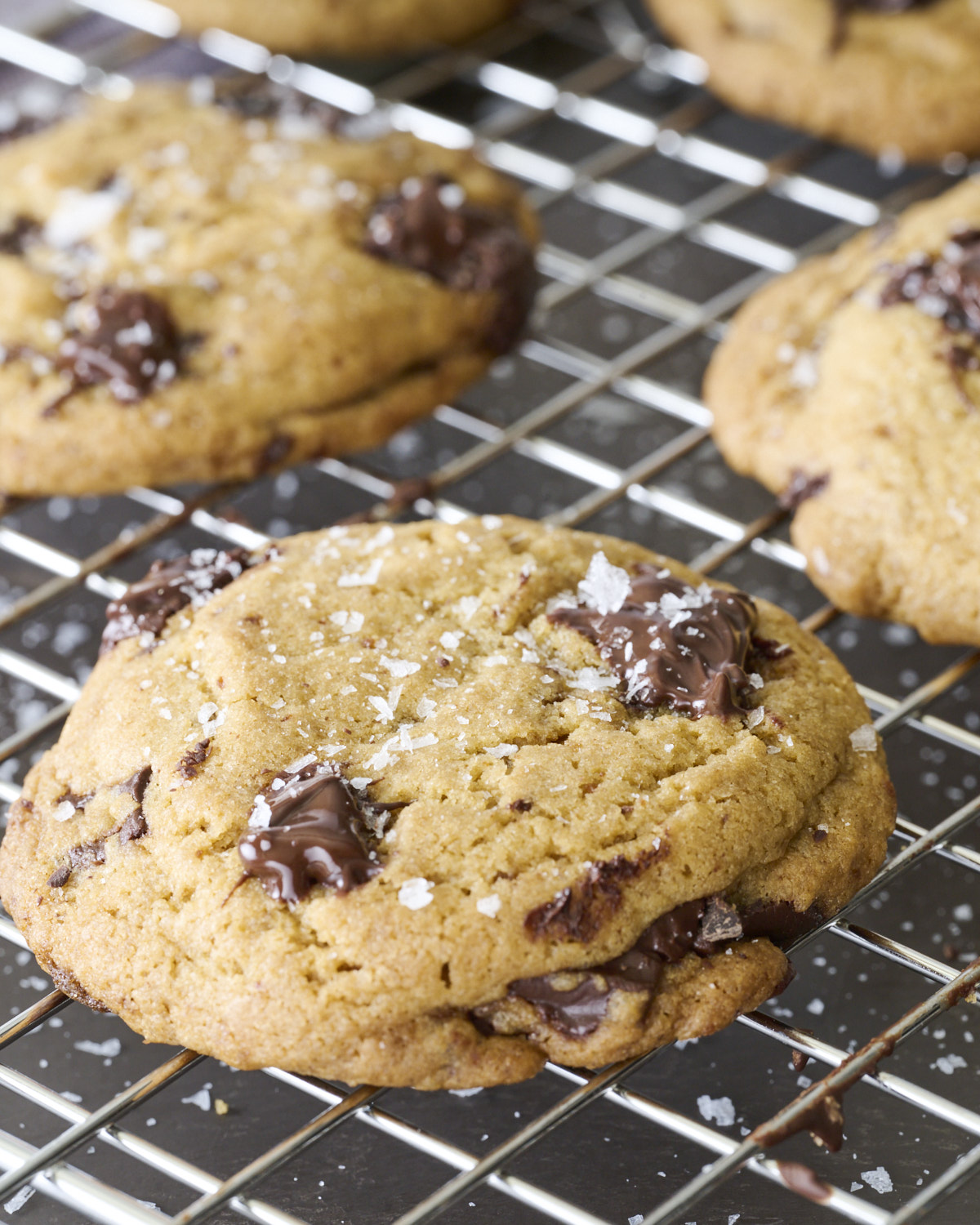 Thick Brown Butter Chocolate Chunk Cookie with melted chocolate chunks and crisp edges resting on a cooling rack.