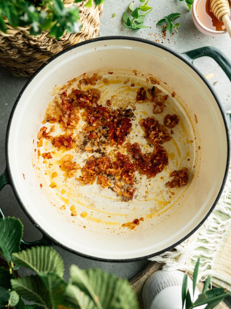 Garlic, herbs, and seasonings cooking in olive oil for homemade marinara sauce