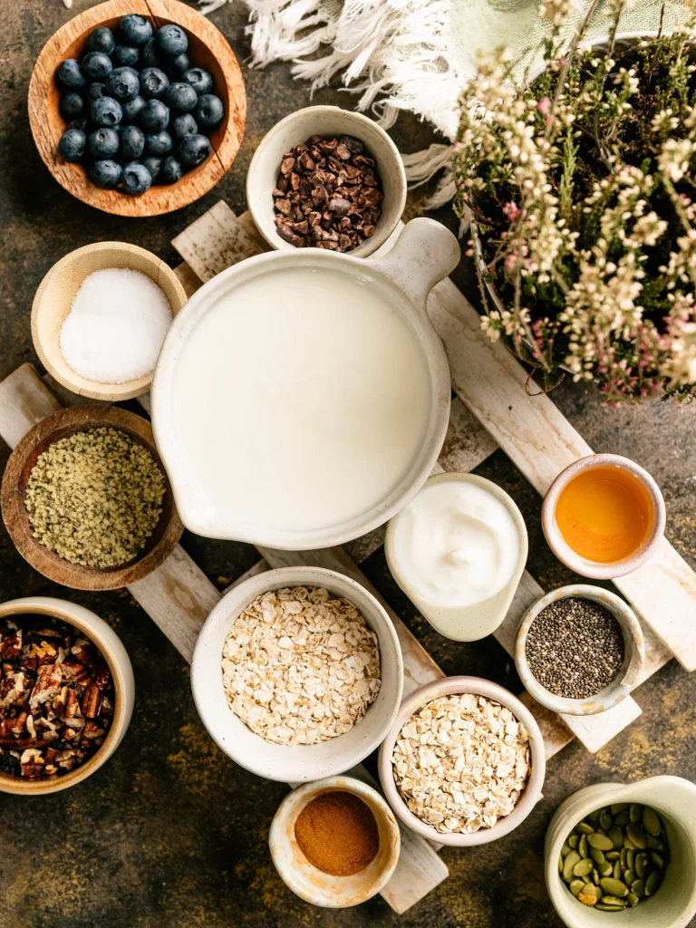 Kefir, rolled oats, blueberries, seeds, honey, and other ingredients for overnight oats